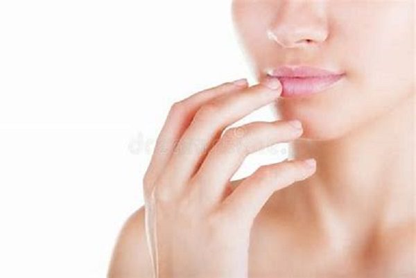 a girl applying lip oil